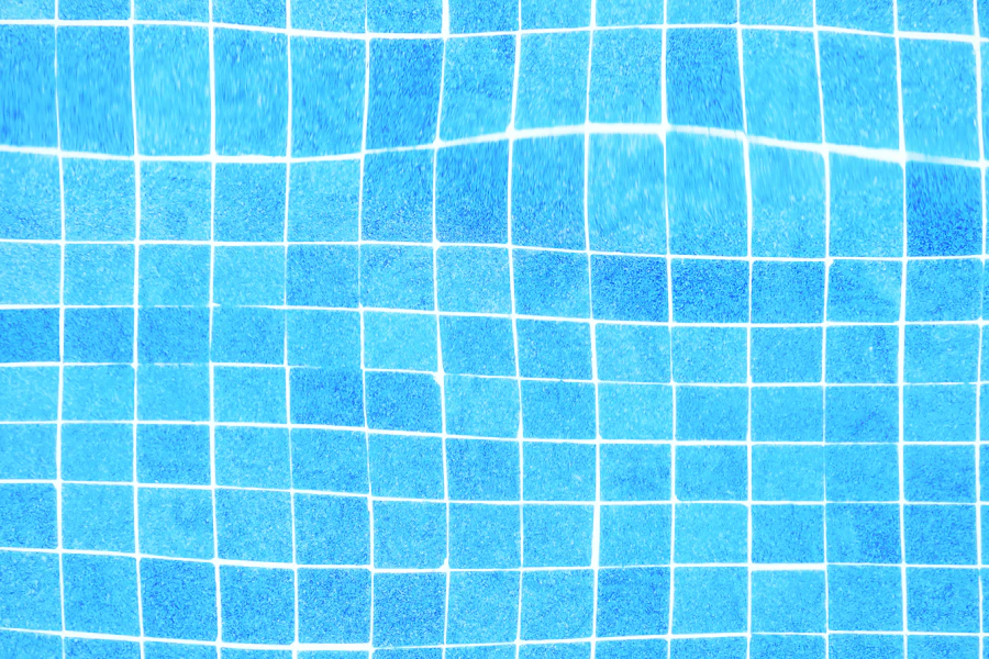 Blue mosaic tile grid beneath clear pool water