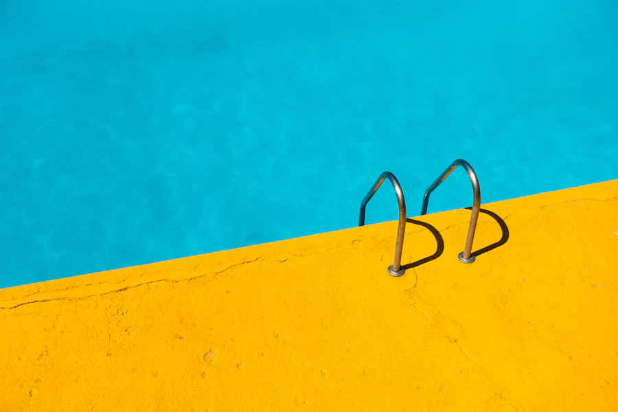 Stainless steel ladder at the edge of a swimming pool